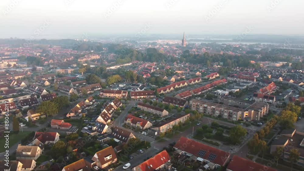 Aerial shot of houses with solar panels on roof in a street in a residential area neighborhood in Steenwijk, Overijssel, The Netherlands, captured during a misty sunrise Aerial shot of houses with solar panels on roof in a street in a residential area neighborhood in Steenwijk, Overijssel, The Netherlands, captured during a misty sunrise