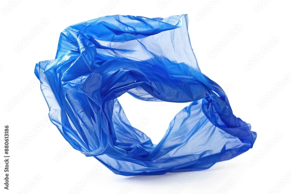 A blue plastic bag lying on a white surface A blue plastic bag lying on a white surface