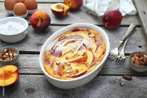 Nectarine clafoutis (flan) with almonds, icing sugar dressing, french cuisine
