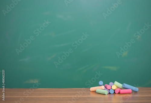 Multicolor chalk on wooden with chalkboard for education background