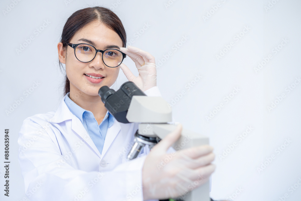 A female scientist is working with a microscope A female scientist is working with a microscope