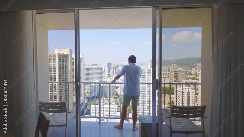 Man talking on the phone and admiring the view of Honolulu city in Hawaii from a balcony in 4k slow motion 60fps Man talking on the phone and admiring the view of Honolulu city in Hawaii from a balcony in 4k slow motion 60fps
