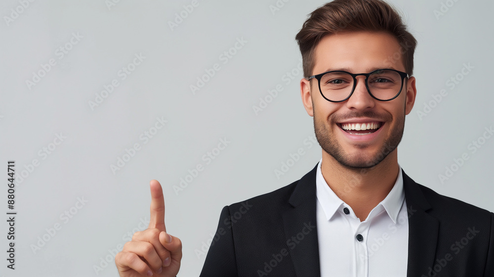 Portrait of a happy businessman pointing finger away over isolated background Portrait of a happy businessman pointing finger away over isolated background