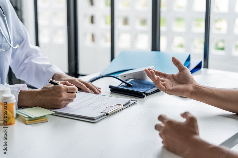 Doctor with patient consultation in medical office. Visiting Physician concept