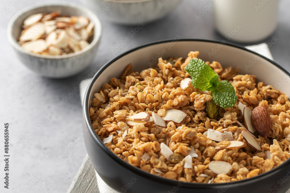 Crispy homemade granola with sliced almonds in a bowl. Healthy food Crispy homemade granola with sliced almonds in a bowl. Healthy food