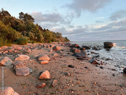 Rocky beach landscape during sunset hours at Zvejniekciems, Latvia.  photo