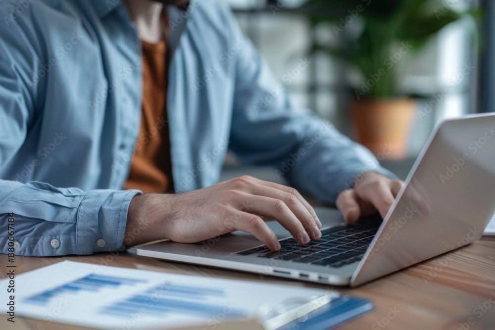 Close-up of a person typing on a laptop at a desk with documents in a modern office. Generated AI Close-up of a person typing on a laptop at a desk with documents in a modern office. Generated AI