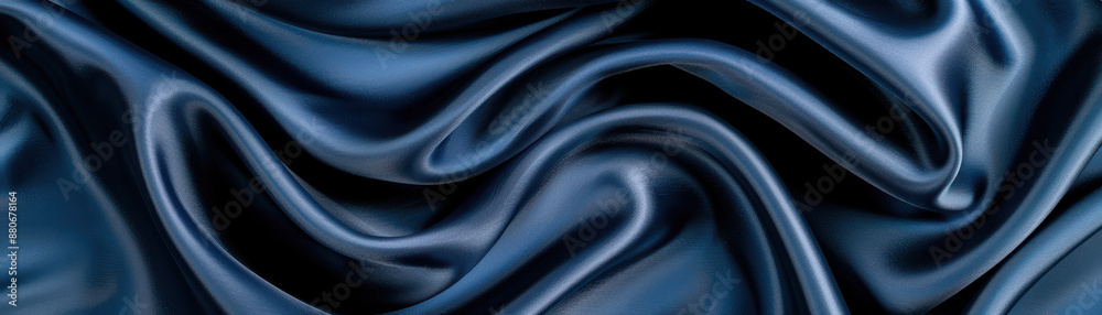 Fototapeta premium Closeup of elegant dark blue satin fabric with soft folds and luxurious texture. Perfect for backgrounds, fashion, and textiles.
