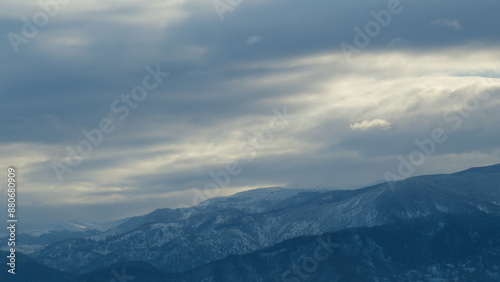 Mountains During Winter Time. Evergreen Tree-Covered Mountain Landscape After A Snow Storm. Timelapse.