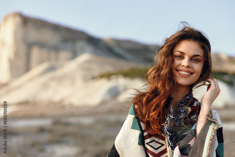 Happy woman posing in front of majestic mountain range with towering peak in the background Happy woman posing in front of majestic mountain range with towering peak in the background