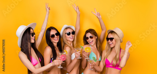 Crazy, funky, summer mood. Cheers to birthday girl Young five excited ladies are enjoing at the hen party near the swimpool in trendy swim wear and sunglasses, caps, having drinks to celebrate photo