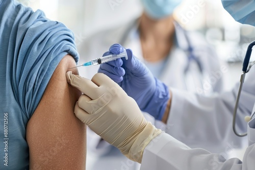 Healthcare worker administering vaccine to patient in clinic. Close-up