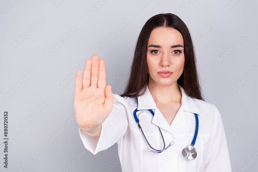 Photo of charming nice woman therapist wear white doctor robe arm stop symbol empty space isolated on grey color background Photo of charming nice woman therapist wear white doctor robe arm stop symbol empty space isolated on grey color background