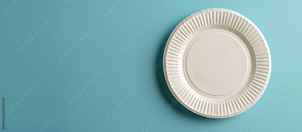 Paper plate attached to blue wall with copy space image Paper plate attached to blue wall with copy space image