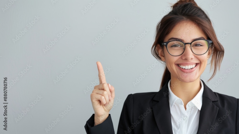 Portrait of a happy young business standing isolated on a light background, showing a hand gesture with his pointing finger to blank space for text or advertisement Portrait of a happy young business standing isolated on a light background, showing a hand gesture with his pointing finger to blank space for text or advertisement