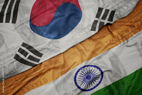 Photography waving colorful flag of india and national flag of south korea on the dollar money background