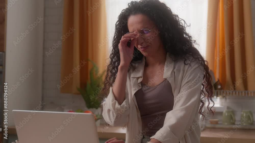 Hispanic woman Latina girl multiracial lady female businesswoman work distant from home business with laptop at kitchen bad feeling headache eyes irritated pain eyestrain take off eyeglasses health Hispanic woman Latina girl multiracial lady female businesswoman work distant from home business with laptop at kitchen bad feeling headache eyes irritated pain eyestrain take off eyeglasses health
