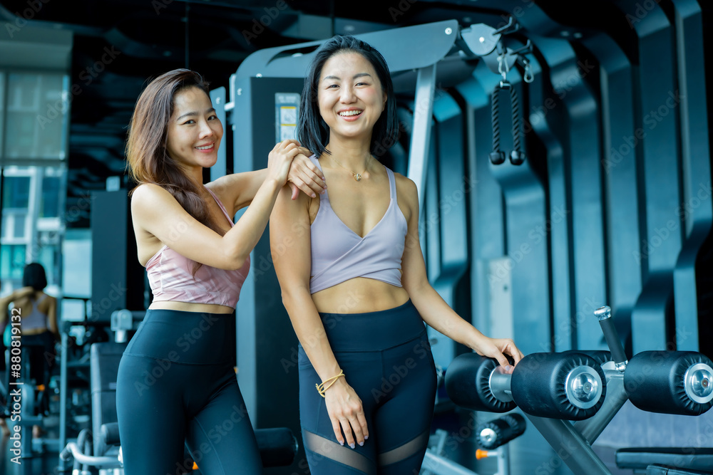 Fototapeta premium Multiethnic group young fitness women training at the gym. Athletic women doing stretches and warming up before workout.