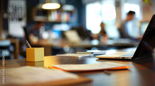 Office Background with Blurry People, Documents, and Laptops