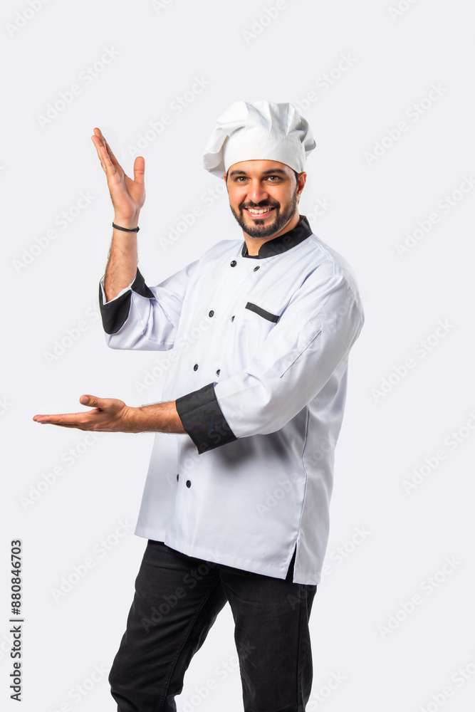Smiling Indian Asian chef or professional cook pointing, isolated white background Smiling Indian Asian chef or professional cook pointing, isolated white background
