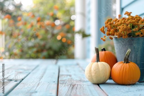 Porch of the backyard decorated with pumpkins and autumn flowers