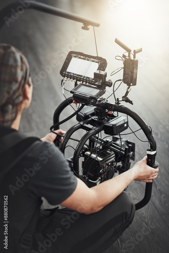 Photographer, camera and filming with stabilizing rig on set for photography, media and magazine. Cameraman, focus and person backstage for shooting, production and equipment as director with lens
