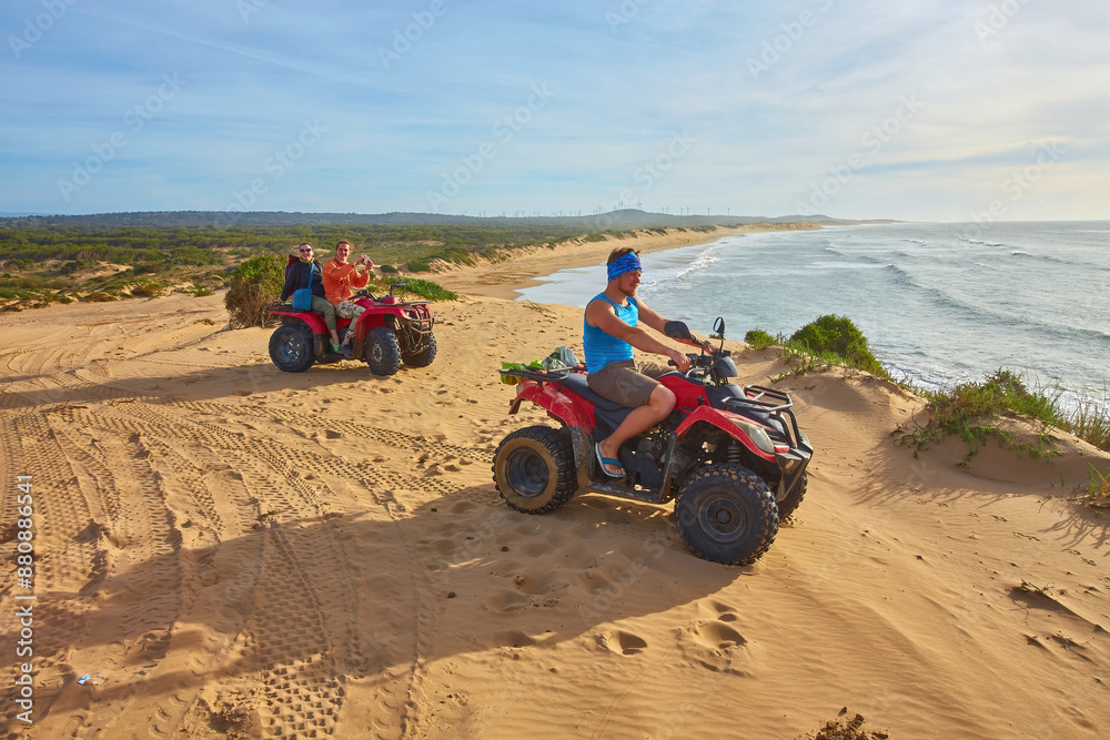 A group of tourists enjoys quad biking along Essaouira's oceanfront A group of tourists enjoys quad biking along Essaouira's oceanfront