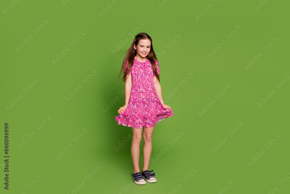 Full size photo of cute schoolgirl empty space wear pink dress isolated on green color background Full size photo of cute schoolgirl empty space wear pink dress isolated on green color background