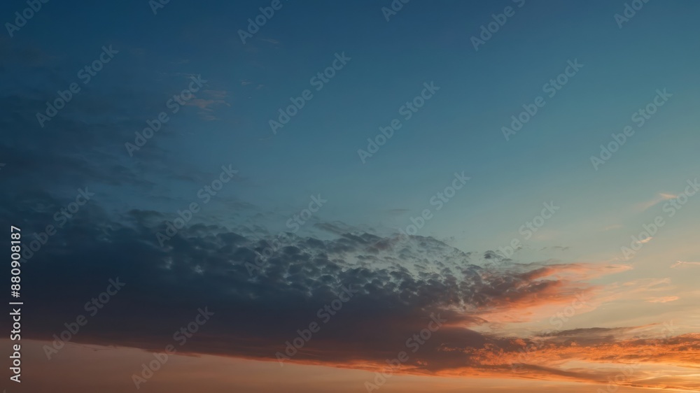 A vibrant sunset sky with a striking gradient of blue and orange hues and scattered clouds, creating a serene and picturesque evening landscape A vibrant sunset sky with a striking gradient of blue and orange hues and scattered clouds, creating a serene and picturesque evening landscape
