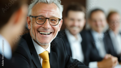 businessman laughs business meeting colleagues black suit yellow tie