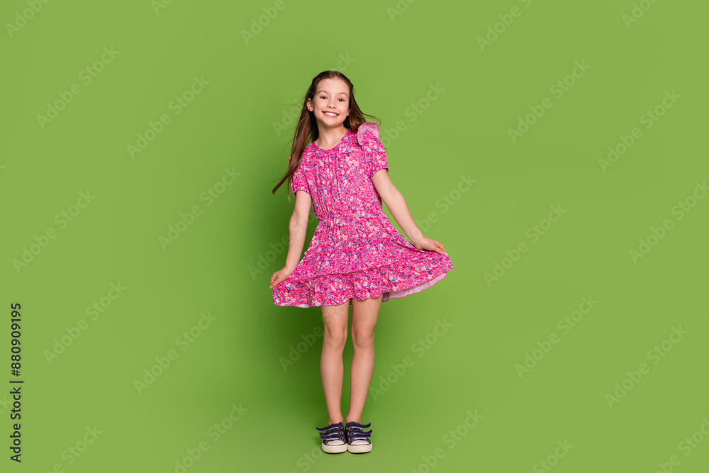 Full size photo of cute schoolgirl wear touch pink dress isolated on green color background Full size photo of cute schoolgirl wear touch pink dress isolated on green color background