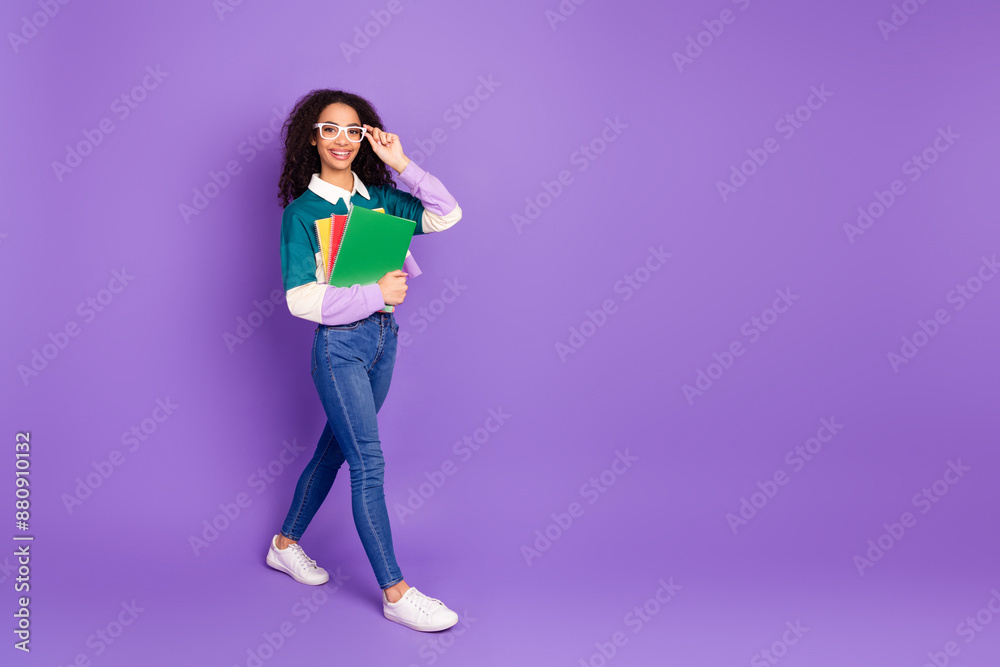Full size photo of nice young girl walk empty space wear shirt isolated on violet color background Full size photo of nice young girl walk empty space wear shirt isolated on violet color background