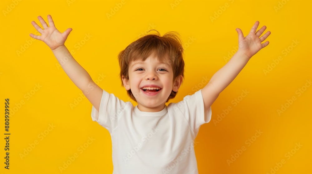 A young boy is smiling and raising his hands in the air. Concept of joy and happiness A young boy is smiling and raising his hands in the air. Concept of joy and happiness