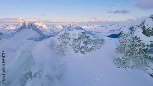 Gliding over lofty snowcloaked summits surrounded by a sea of clouds. photo