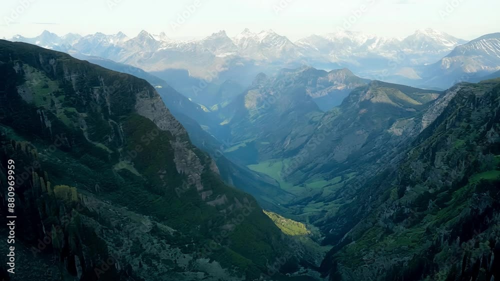 A birds eye view of lush valleys surrounded by rugged mountain ranges A birds eye view of lush valleys surrounded by rugged mountain ranges