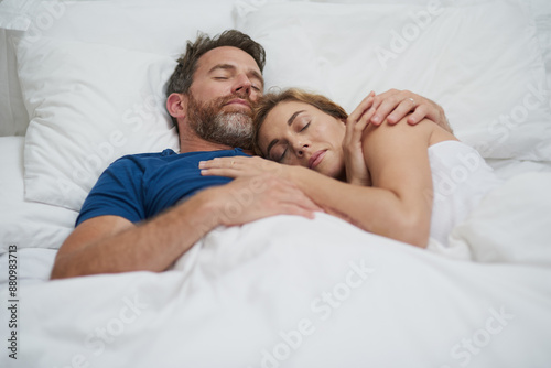 Fotografija Tired, couple and cuddle with sleep in bedroom for marriage, commitment and comfort in love at home