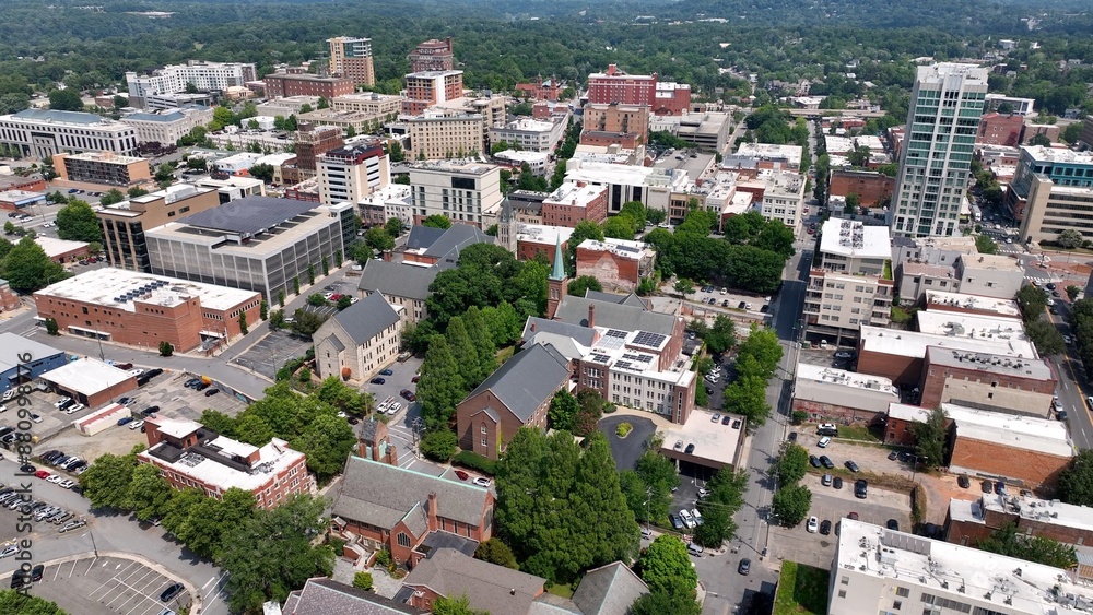City skyline of Asheville, NC at the base of the Blue Ridge Mountains in North Carolina, a living and vacation destination in the Southern, United States showing architecture of buildings and streets City skyline of Asheville, NC at the base of the Blue Ridge Mountains in North Carolina, a living and vacation destination in the Southern, United States showing architecture of buildings and streets