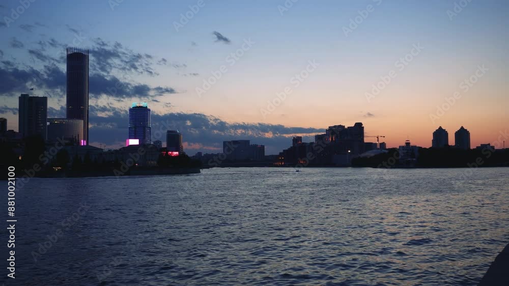 Evening city, beautiful sunset on the waterfront Evening city, beautiful sunset on the waterfront