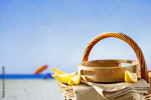 Empty summer picninc basket on sunny tropical sandy beach with copy space for products and objects. Summer concept  background. photo