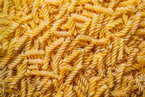 Flat lay photography of uncooked fusilli pasta creating a textured background for projects