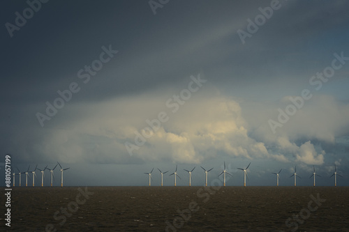 View of Gunfleet sands offshore windfarm against a stormy sky taken from the shore of Clacton on sea, Essex, UK.