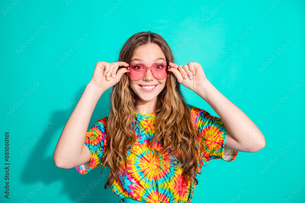 Photo portrait of lovely teen lady sunglass enjoy summer vacation dressed stylish colorful garment isolated on cyan color background Photo portrait of lovely teen lady sunglass enjoy summer vacation dressed stylish colorful garment isolated on cyan color background