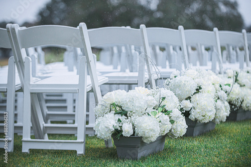 Lush green wedding isle with white chairs and rows of hydrangea lined before alter florida wedding