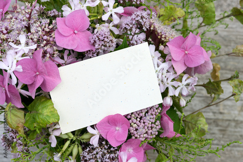 Summer bouquet with pink hydrangeas, soapwort, oregano and card with copy space