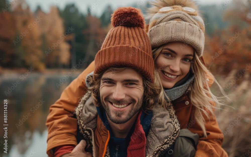 A man and a woman are smiling and posing for a picture. They are wearing hats and jackets, and the man is holding the woman on his back. Scene is happy and playful A man and a woman are smiling and posing for a picture. They are wearing hats and jackets, and the man is holding the woman on his back. Scene is happy and playful