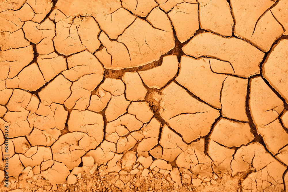 Cracked Earth. An arid landscape with cracked, dry earth patterns in a warm orange hue. Cracked Earth. An arid landscape with cracked, dry earth patterns in a warm orange hue.
