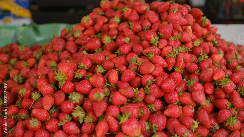 Strawberry. Harvest of ripe red strawberries at a street market, beautifully laid out. Sweet and tasty red fresh berries. Vegetarian food, nutrition concept. Strawberry fruit background close up