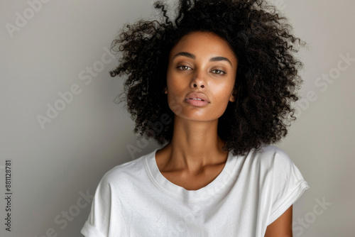  Beautiful black woman wearing bella canvas white t shirt and jeans, studio shot. Design t shirt template, print presentation mockup