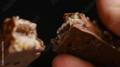 I separate the chocolate filling into two parts, close-up. Close-up of a chocolate bar. Chocolate.