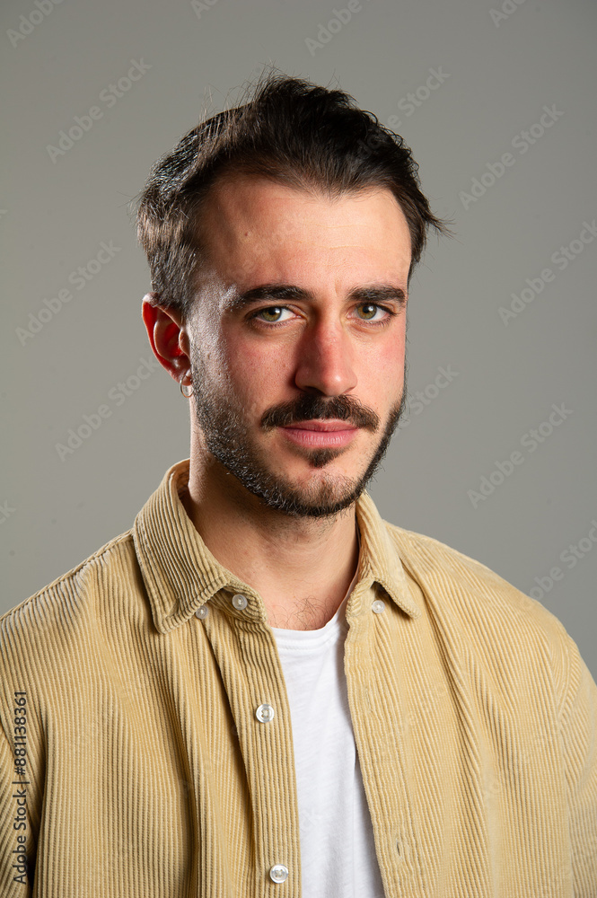 Young man with mustache is posing on a grey background Young man with mustache is posing on a grey background